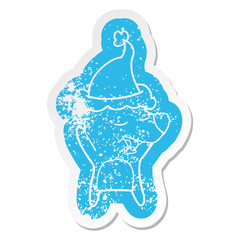 cartoon distressed sticker of a bear wearing santa hat