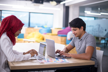 black muslim business woman having a meeting with her indian male colleague