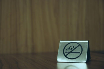 Warning sign. no smoking on the table in the room. Iron plate on the table does not smoke close-up. horizontal view. copy space