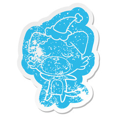 cute cartoon distressed sticker of a dog wearing santa hat