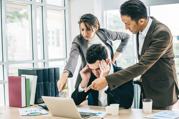 Businessman worry about his job with serious boss discussing while commenting a financial report...