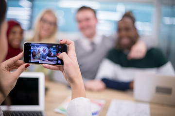 businesswoman using mobile phone for taking photo