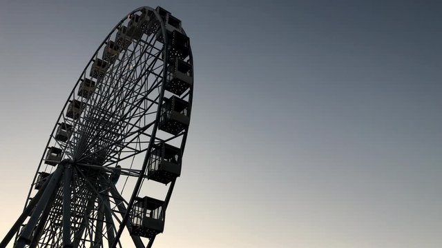 Ferris wheel. High carousel against the sky.
