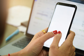 Woman holding smart phone with bank moblie can be add your texts or others. at office