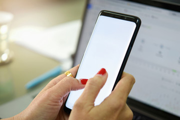 Woman holding smart phone with bank moblie can be add your texts or others. at office