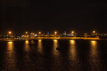 Fototapeta na wymiar Night view of the port of Bari with the illuminated city in the background