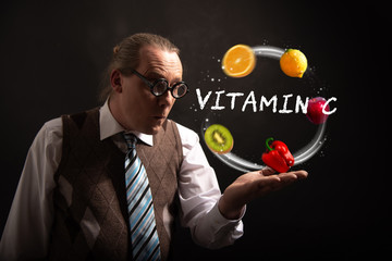Funny nerd or geek juggles with fruits and vegetables vitamin c