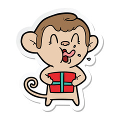 sticker of a crazy cartoon monkey with christmas present