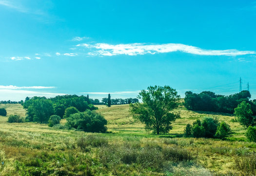 Village green field seen on the train journey from Rome to Florence in the morning during sunrise