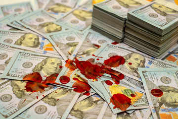 Stack bundles of 100 US dollars banknotes bloody
