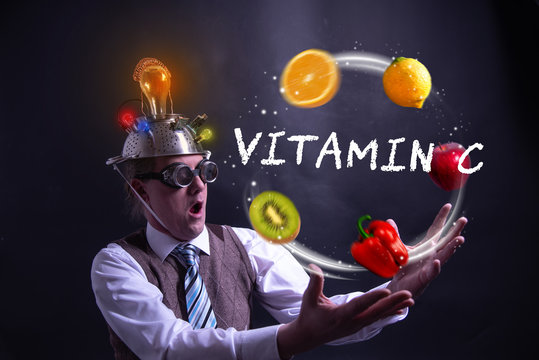 Funny Nerd Or Geek Juggles With Fruits And Vegetables Vitamin C
