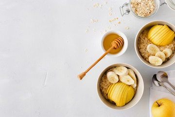 Healthy breakfast Oatmeal fruits copy space honey white background