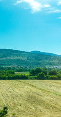 Italy, Rome to Florence train, a field with a mountain in the background
