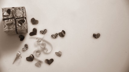 Colourful heart shape ribbon with small gift boxes on colorful bokeh, flare, vintage background.	