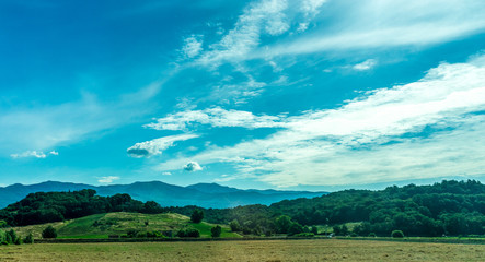 Italy, Rome to Florence train, a large green field with a mountain in the background