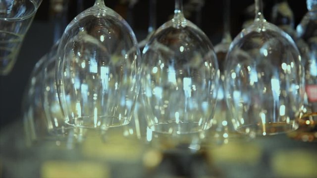 Close up of empty glasses hanged up in a bar