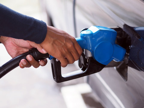 Closeup Hand Man Pumping Gasoline Fuel In Car At Gas Station.