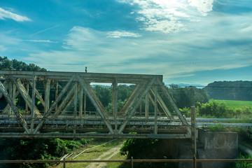 Obraz premium Italy, Rome to Florence train, a bridge over a body of water