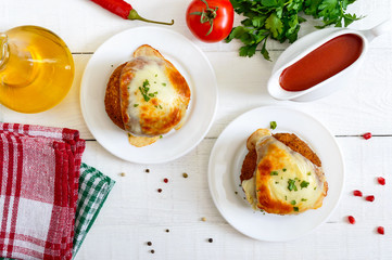Potato balls with minced meat in deep fat, baked with mozzarella. Top view.
