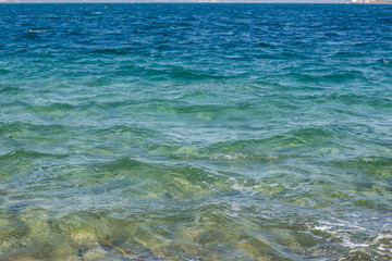 vivid blue colorful sea water surface with small waves in perspective foreshortening background