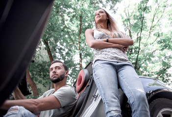 young couple traveling by car makes a stop