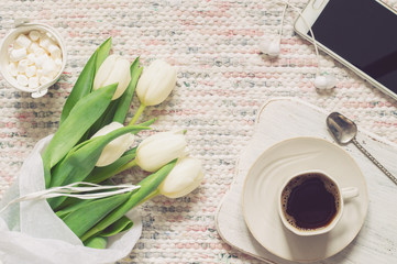Bouquet of white tulips, coffee and phone