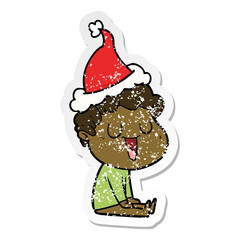 laughing distressed sticker cartoon of a man wearing santa hat