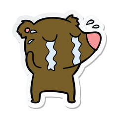 sticker of a cartoon crying bear
