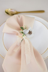 wedding table decorated by plates, knives and forks