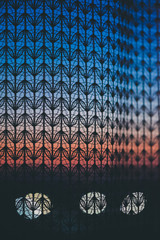 Amazing romantic sunset in window behind silhouettes of tulle texture. Wonderful grapefruit blue dawn sky from window through patterned curtain. Cosiness background of scenic sunrise. Copy space.