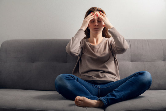 Young attractive woman in depression with a headache.
