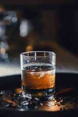 Refreshing soft drink. Cola and ice in the glass. Water droplets on the glass.