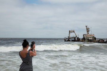 Photographer shooting shipwreck