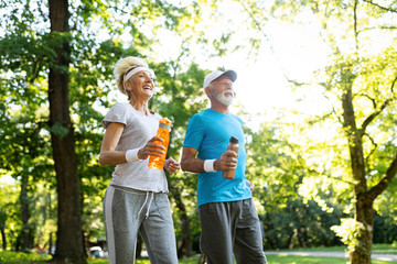 Fototapeta premium Mature couple jogging and running outdoors in city