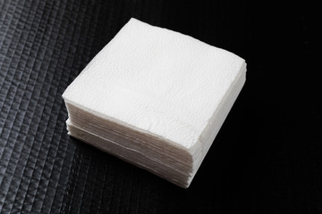 Paper napkin on black background.