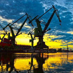 Big shipyard cranes at sunset in Gdansk, Poland.