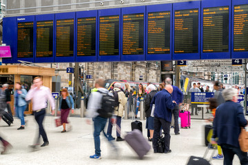 People walking with luggage at Glasgow central statton