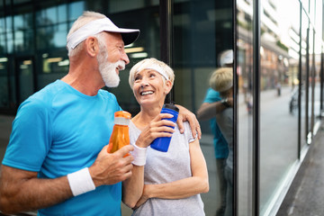 Senior couple staying hydrated after running jogging