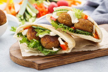 Healthy vegetarian falafel pita with fresh vegetables and sauce