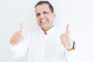Middle age man doing postive gesture with thumbs up smiling to the camera
