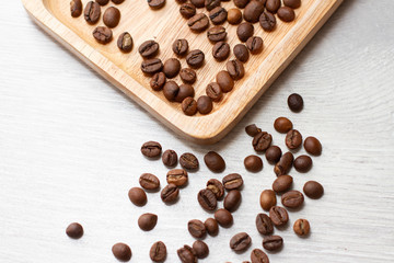 coffee grains on a wooden plate