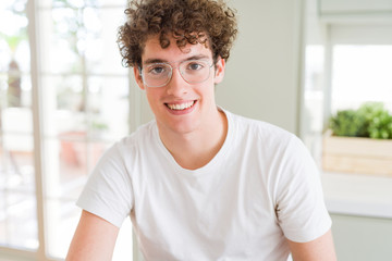 Fototapeta premium Young handsome man wearing glasses with a happy and cool smile on face. Lucky person.
