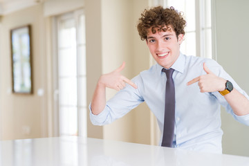 Young business man wearing a tie looking confident with smile on face, pointing oneself with...