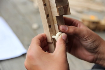 Child's hand, fold and stick a wooden toy