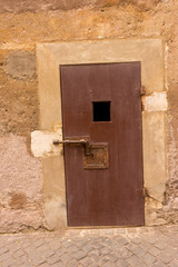 Door with a square hole and latch