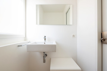Obraz na płótnie Canvas Front view with sink, mirror and window
