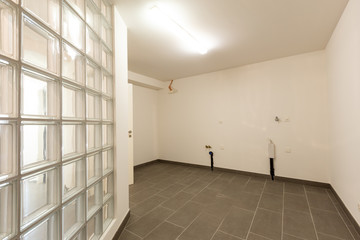 Cellar with gray tiles and white walls
