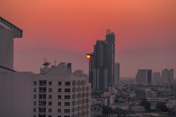 The background of the high angle view in the evening, overlooking the condominium that is under construction in a variety of heights, showing the habitat of the capital city.