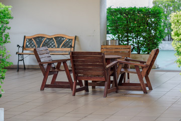 The background of a wooden chair, wooden table, a wall decoration or a sitting area in the house (coffee shop, condominium) to sit and relax during the day