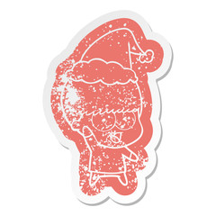 happy cartoon distressed sticker of a boy waving wearing santa hat